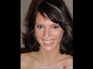 Jennifer dark is sited on a sofa, legs appart and looking at you