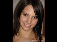 Monica vesela is sited on a sofa, legs appart and looking at you