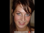 Alena is sited on a sofa, legs appart and looking at you