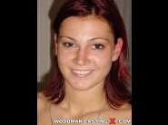 Denisa is sited on a sofa, legs appart and looking at you