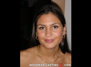 Indira is sited on a sofa, legs appart and looking at you