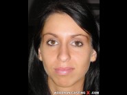 Lisa sparkle is sited on a sofa, legs appart and looking at you