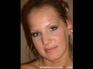 Kira banks is sited on a sofa, legs appart and looking at you