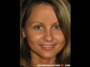 Zoe l-fox is sited on a sofa, legs appart and looking at you