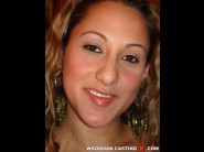 Josy is sited on a sofa, legs appart and looking at you