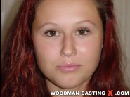 Iyana is sited on a sofa, legs appart and looking at you