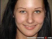 Loulou is sited on a sofa, legs appart and looking at you