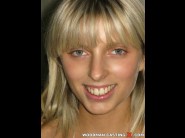 Stella delcroix is sited on a sofa, legs appart and looking at you