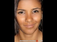 Vivienne is sited on a sofa, legs appart and looking at you