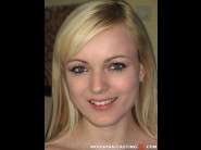 Bianca golden is sited on a sofa, legs appart and looking at you