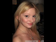 Sophie may is sited on a sofa, legs appart and looking at you