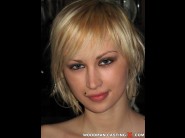 Inga is sited on a sofa, legs appart and looking at you