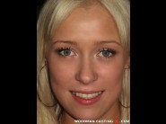 Teena doll is sited on a sofa, legs appart and looking at you