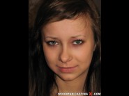 Nastia is sited on a sofa, legs appart and looking at you