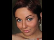 Graziella is sited on a sofa, legs appart and looking at you