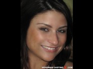 Bellina is sited on a sofa, legs appart and looking at you