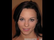 Alysa is sited on a sofa, legs appart and looking at you