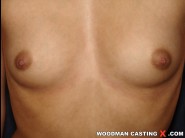 Pavlina is sited on a sofa, legs appart and looking at you