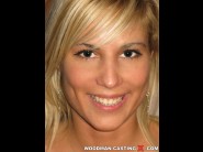 Katalyn is sited on a sofa, legs appart and looking at you