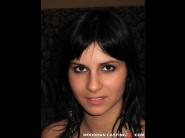 Naomie is sited on a sofa, legs appart and looking at you