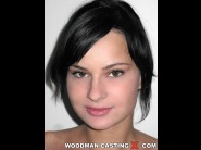 Abbie cat is sited on a sofa, legs appart and looking at you