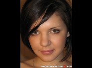 Alina henessy is sited on a sofa, legs appart and looking at you