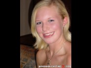 Theresa is sited on a sofa, legs appart and looking at you