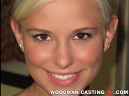 Dido angel is sited on a sofa, legs appart and looking at you