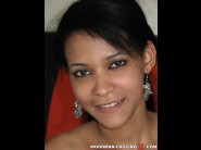 Beatris is sited on a sofa, legs appart and looking at you