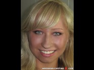 Nika star is sited on a sofa, legs appart and looking at you