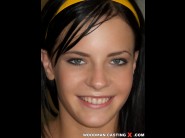 Liz is sited on a sofa, legs appart and looking at you