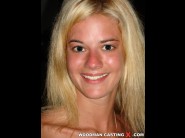 Chloe delaure is sited on a sofa, legs appart and looking at you