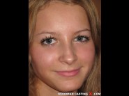 Sabina gruda is sited on a sofa, legs appart and looking at you