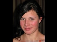 Adrienn is sited on a sofa, legs appart and looking at you