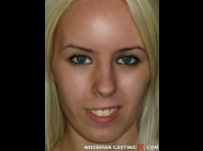 Alexa is sited on a sofa, legs appart and looking at you