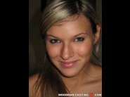 Krystal is sited on a sofa, legs appart and looking at you