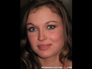 Renata is sited on a sofa, legs appart and looking at you