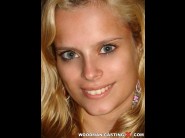 Ivy is sited on a sofa, legs appart and looking at you