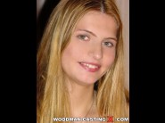 Monika is sited on a sofa, legs appart and looking at you