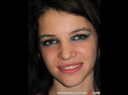 Georgina is sited on a sofa, legs appart and looking at you