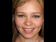 Nikitta is sited on a sofa, legs appart and looking at you