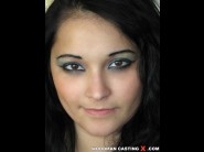 Katy is sited on a sofa, legs appart and looking at you