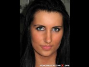 Melissa ria is sited on a sofa, legs appart and looking at you