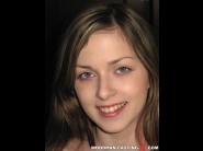 Abigaile johnson is sited on a sofa, legs appart and looking at you