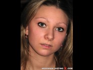 Viktoria is sited on a sofa, legs appart and looking at you