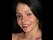 Zara is sited on a sofa, legs appart and looking at you