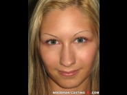 Cindy white is sited on a sofa, legs appart and looking at you