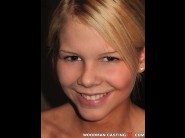 Cherry pink is sited on a sofa, legs appart and looking at you