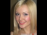 Logan is sited on a sofa, legs appart and looking at you