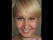 Amelie pure is sited on a sofa, legs appart and looking at you